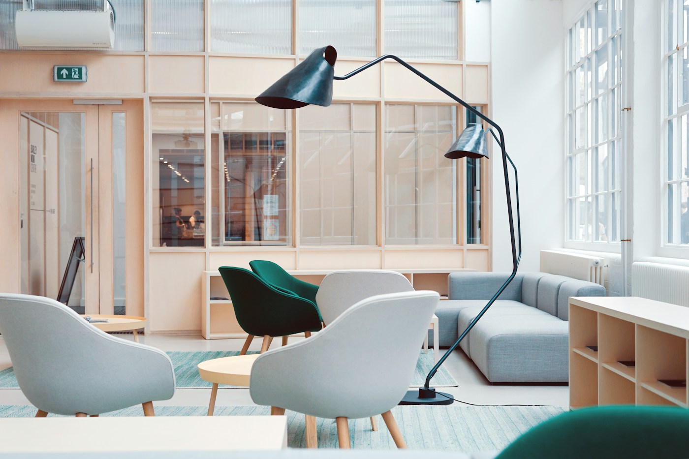 Bright shared studio with contemporary furniture and glass meeting rooms